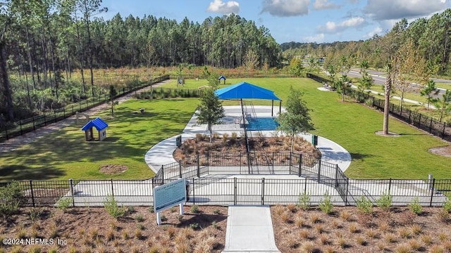 view of property's community with a gazebo, a lawn, and fence