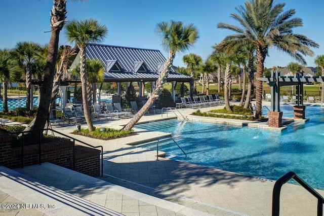 community pool with a gazebo and a patio