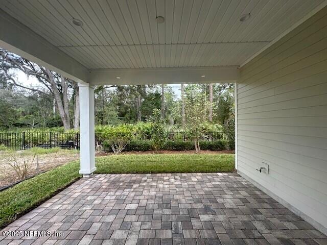 view of patio featuring fence