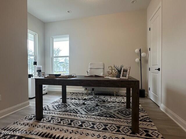 office space featuring baseboards and light wood-style floors