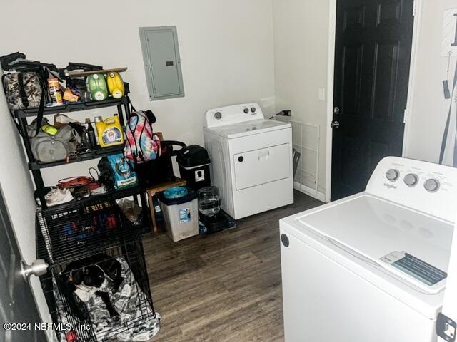 washroom with washer and clothes dryer, electric panel, and dark hardwood / wood-style floors