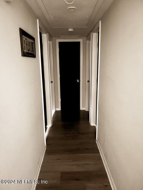 hallway featuring dark wood-type flooring