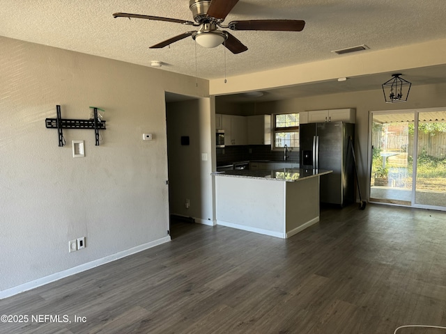 kitchen with white cabinetry, dark hardwood / wood-style floors, a healthy amount of sunlight, and appliances with stainless steel finishes