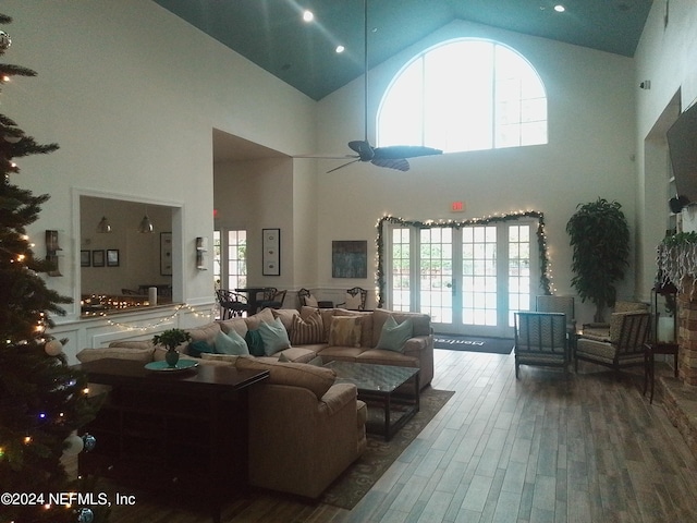 living room featuring high vaulted ceiling, hardwood / wood-style floors, ceiling fan, and a healthy amount of sunlight