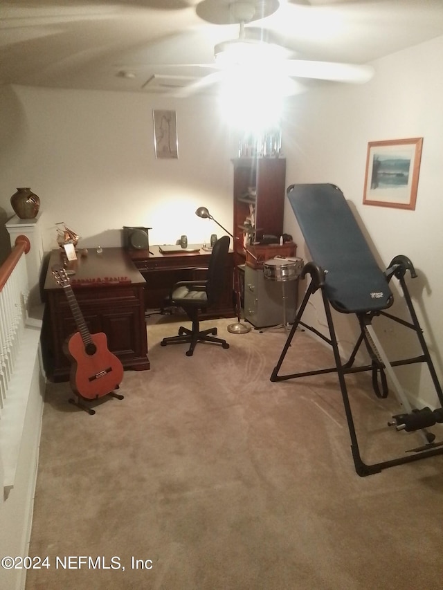 carpeted home office featuring ceiling fan