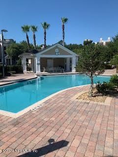 view of pool featuring an outdoor structure and a patio area