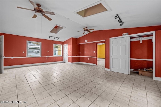 unfurnished living room featuring light tile patterned floors, visible vents, baseboards, lofted ceiling, and ceiling fan