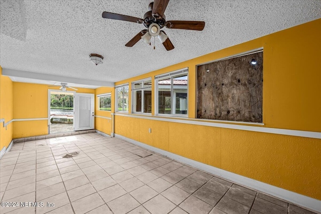 unfurnished sunroom with a ceiling fan