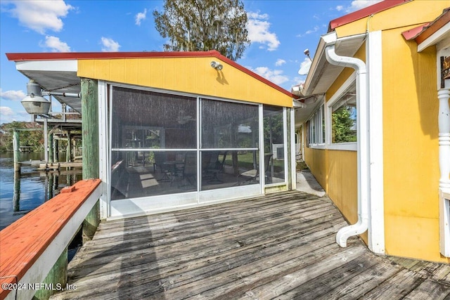 exterior space with a sunroom and a water view