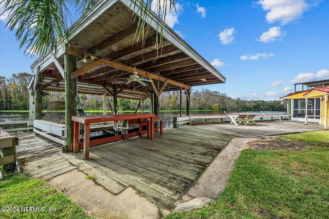 surrounding community with a water view, boat lift, and a boat dock