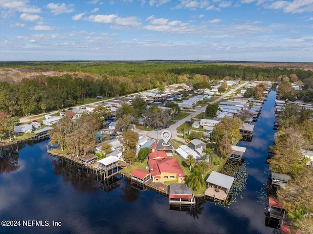 aerial view with a water view and a forest view