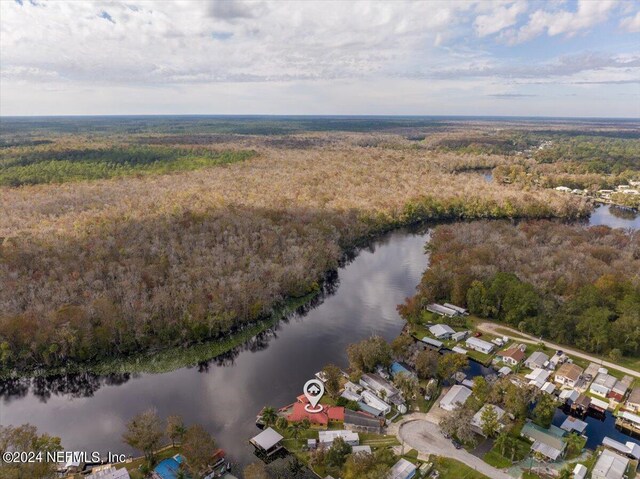 drone / aerial view featuring a water view and a view of trees