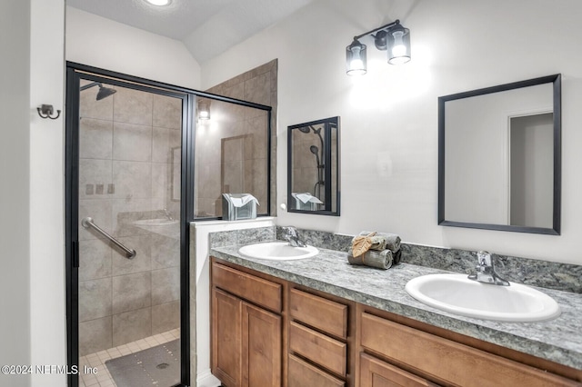 bathroom featuring vanity and a shower with shower door