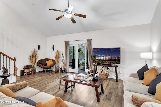 living room with hardwood / wood-style flooring, lofted ceiling, and ceiling fan