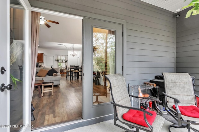 exterior space with ceiling fan with notable chandelier