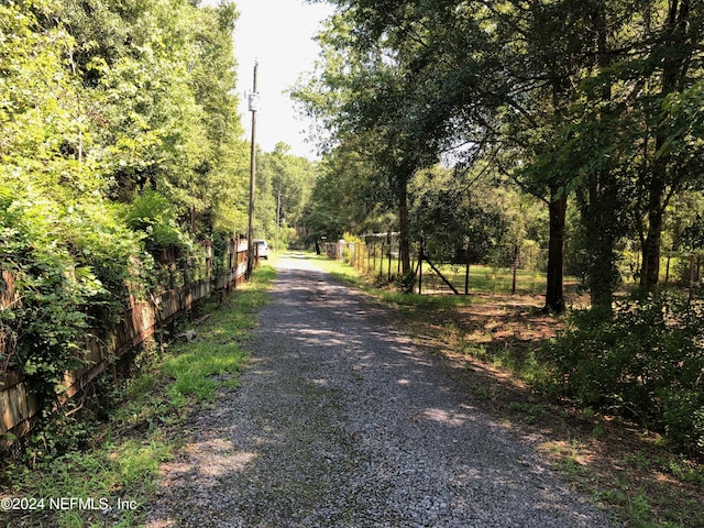 view of road with a wooded view