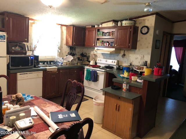 kitchen with white appliances, crown molding, light tile patterned floors, a textured ceiling, and extractor fan