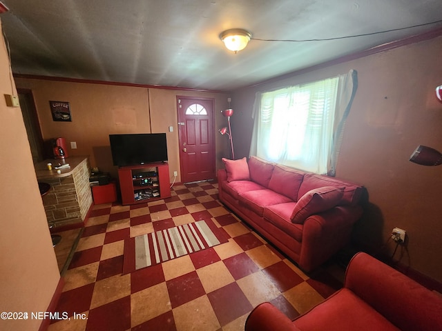 living room featuring ornamental molding and tile flooring