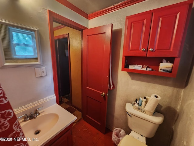 bathroom with tile floors, toilet, ornamental molding, and vanity