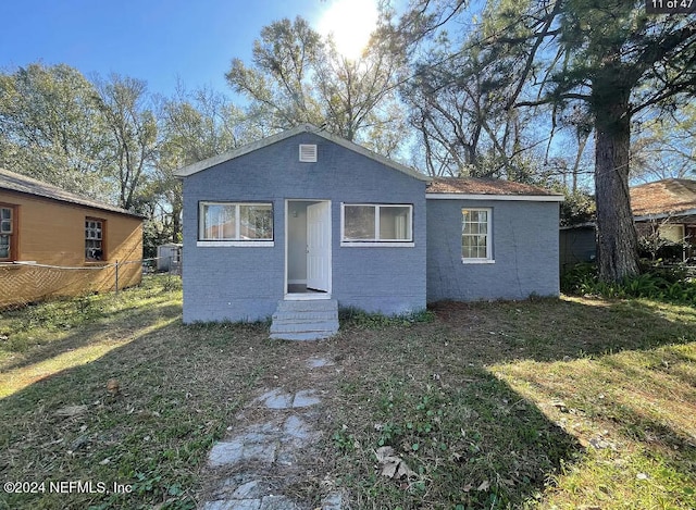 back of property featuring a lawn