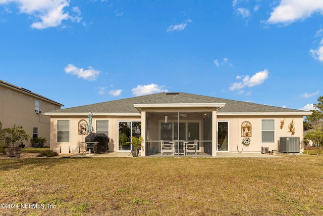 rear view of house featuring a lawn, a patio, and central AC unit