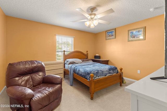 bedroom with light carpet, a textured ceiling, and ceiling fan