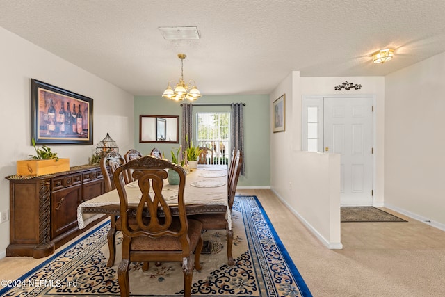 carpeted dining area featuring a notable chandelier and a textured ceiling