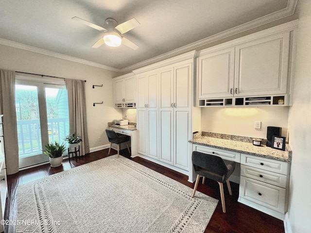 home office featuring ceiling fan, ornamental molding, built in desk, and dark hardwood / wood-style flooring