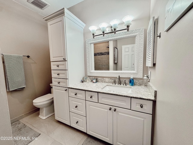 bathroom featuring toilet, tile patterned floors, walk in shower, and vanity