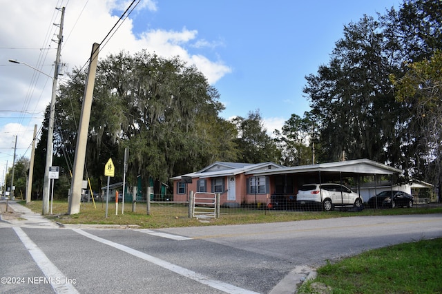 view of front of house with a front lawn and a carport