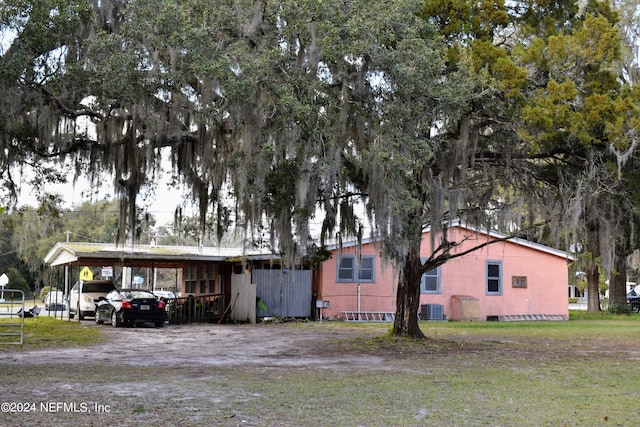 exterior space featuring a carport and central AC