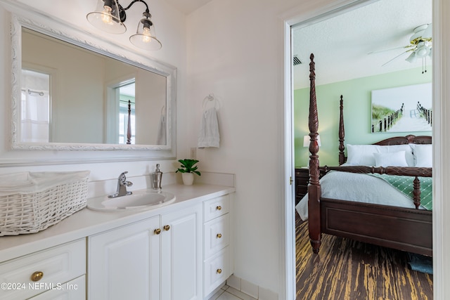 bathroom with ceiling fan, vanity, and hardwood / wood-style floors