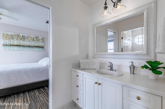 bathroom with ceiling fan and vanity