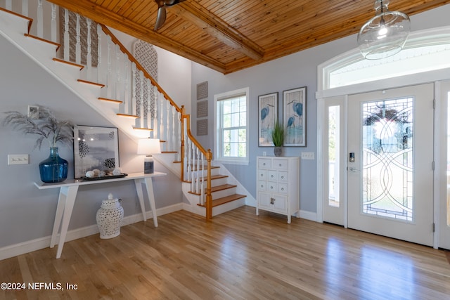 entrance foyer featuring beamed ceiling, wooden ceiling, and light wood-type flooring