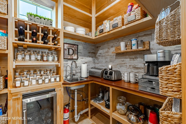 wine room featuring wine cooler and sink