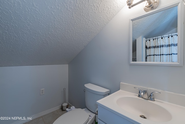 bathroom featuring vaulted ceiling, toilet, a textured ceiling, vanity, and tile floors