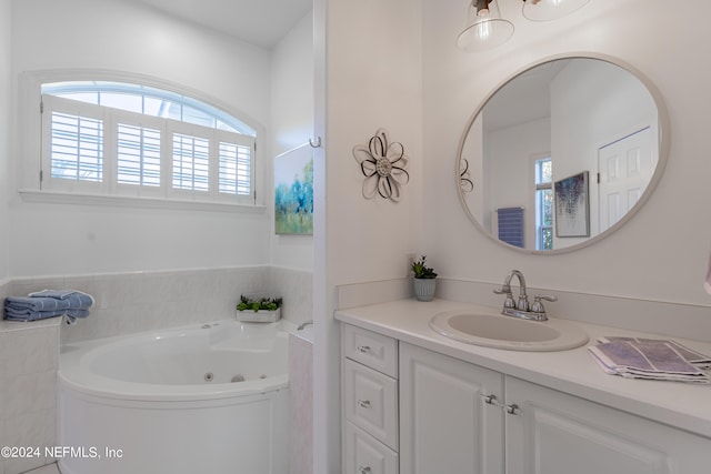 bathroom featuring a bath to relax in and oversized vanity