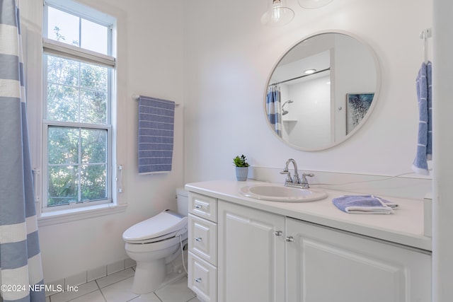 bathroom with tile flooring, oversized vanity, and toilet