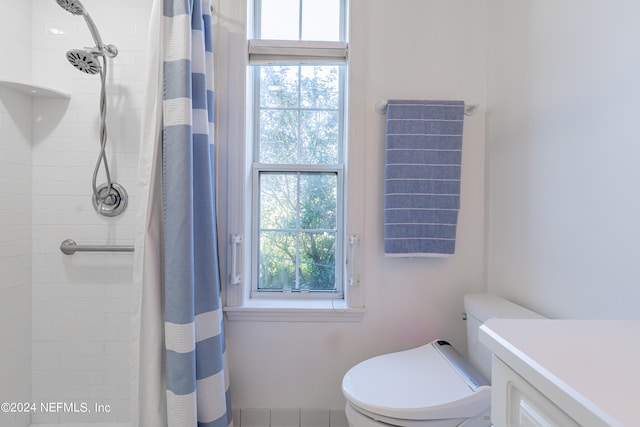 bathroom featuring toilet and a shower with curtain