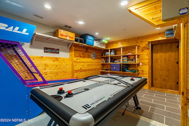 playroom with wood walls and tile flooring