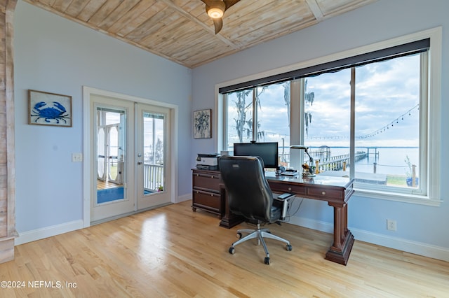 office with wood ceiling, light hardwood / wood-style floors, and a wealth of natural light