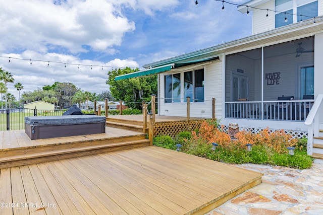 wooden terrace featuring a covered hot tub