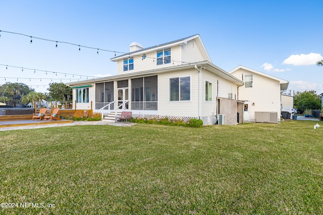 view of front of home featuring a sunroom and a front lawn