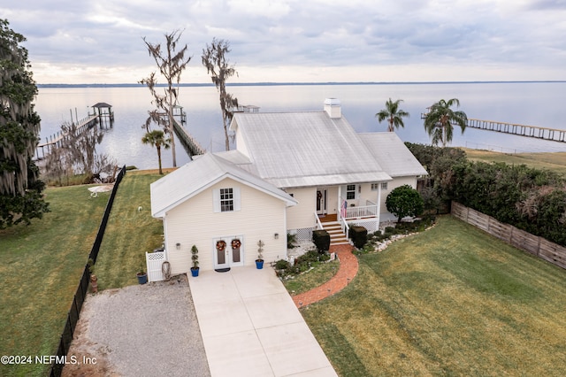 birds eye view of property with a water view