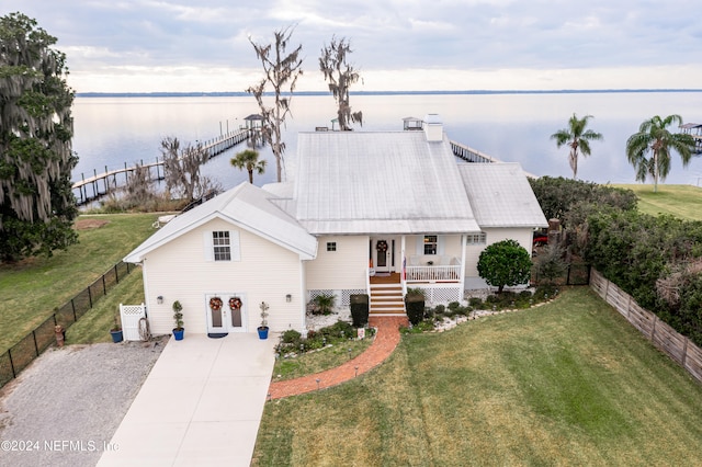 view of front facade featuring a front yard and a water view