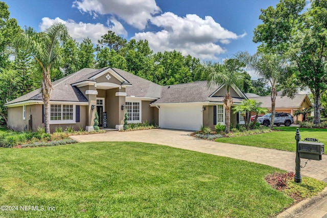 view of front of house with a front yard and a garage