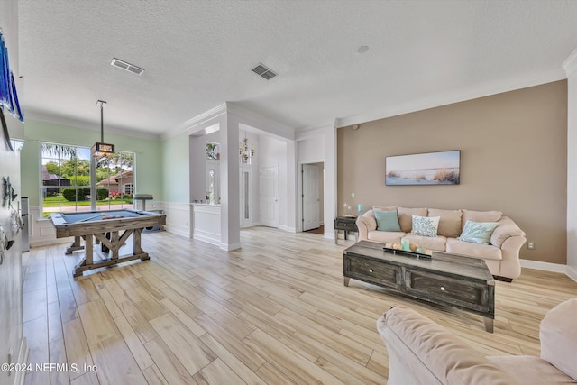 game room with a textured ceiling, light hardwood / wood-style flooring, crown molding, and billiards