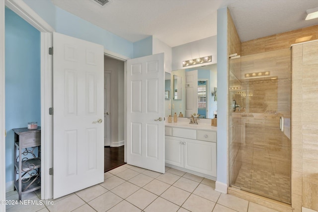 bathroom featuring a textured ceiling, tile patterned floors, and walk in shower