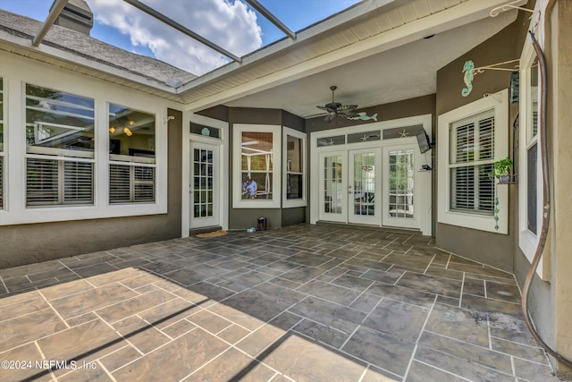 view of patio / terrace with glass enclosure, ceiling fan, and french doors