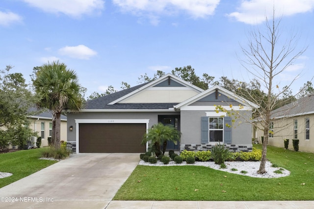 view of front of house featuring a front yard and a garage